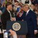 NFL quarterback Jaxson Dart shaking hands with former President Donald Trump at a podium during a Fighting For American Workers event.