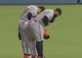 Giants outfielders bow after their win over the Dodgers on May 12, 2026.
