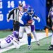 New York Giants player Deonte Banks runs the ball as Minnesota Vikings player Ivan Pace Jr. tackles him.