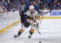 Vegas Golden Knights player Brett Howden with the puck, pursued by Colorado Avalanche player Brock Nelson.