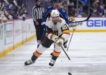 Vegas Golden Knights player Brett Howden with the puck, pursued by Colorado Avalanche player Brock Nelson.