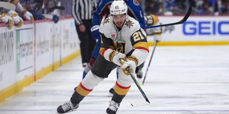 Vegas Golden Knights player Brett Howden with the puck, pursued by Colorado Avalanche player Brock Nelson.
