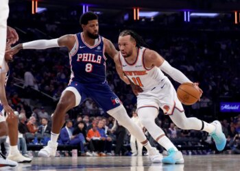New York Knicks guard Jalen Brunson (11) drives to the basket as Philadelphia 76ers forward Paul George (8) defends.