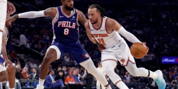 New York Knicks guard Jalen Brunson (11) drives to the basket as Philadelphia 76ers forward Paul George (8) defends.