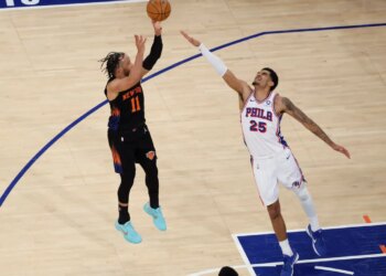 New York Knicks guard Jalen Brunson (11) shoots over Philadelphia 76ers forward Dominick Barlow (25).