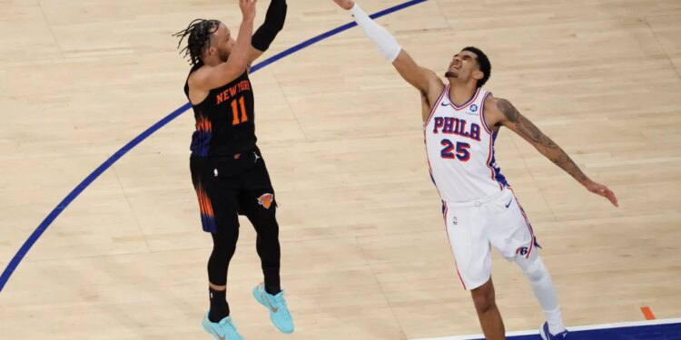 New York Knicks guard Jalen Brunson (11) shoots over Philadelphia 76ers forward Dominick Barlow (25).