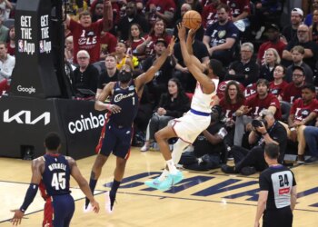 New York Knicks guard Mikal Bridges (25) shoots as Cleveland Cavaliers guard James Harden (1) defends.