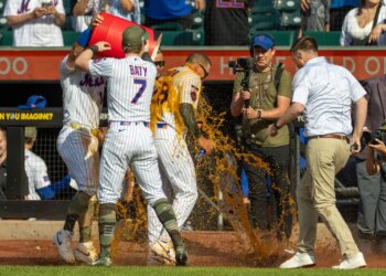 New York Mets players dump a cooler of Bodyarmor on center fielder Tyrone Taylor during a celebration.
