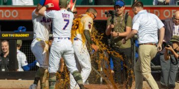 New York Mets players dump a cooler of Bodyarmor on center fielder Tyrone Taylor during a celebration.