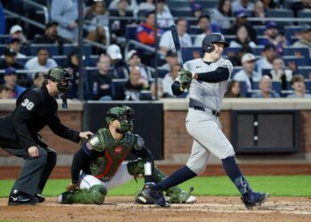 Yankees first baseman Ben Rice hitting a single during a game.
