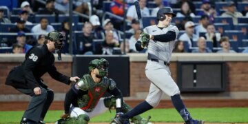 Yankees first baseman Ben Rice hitting a single during a game.