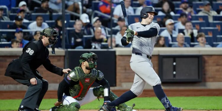 Yankees first baseman Ben Rice hitting a single during a game.