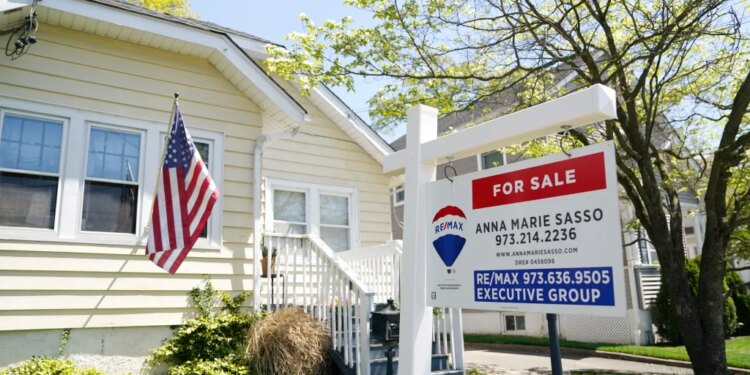 A single-family home with a "For Sale" sign in the front yard.