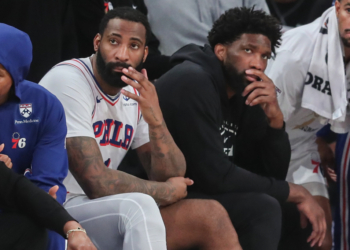 Andre Drummond and Joel Embiid on the bench during an NBA Playoffs game.