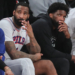Andre Drummond and Joel Embiid on the bench during an NBA Playoffs game.