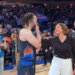 Jalen Brunson with a woman on a basketball court.