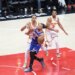 New York Knicks guard Jalen Brunson (11) drives to the basket against two Atlanta Hawks players.