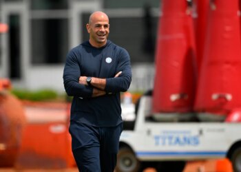 Robert Saleh, head coach for the Tennessee Titans, smiling with his arms crossed during the NFL team's rookie minicamp.