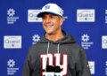 New York Giants head coach John Harbaugh speaking at a press conference.