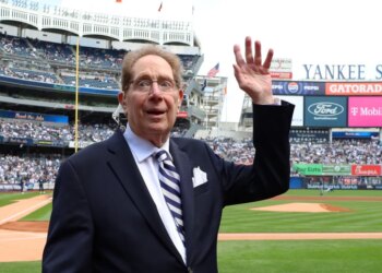 John Sterling waves to the crowd while he is honored by the Yankees in a pre-game ceremony as he retires as âThe Voice Of The Yankeesâ when the New York Yankees played the Tampa Bay Rays Saturday, April 20, 2024 at Yankee Stadium in the Bronx, NY. (For the NY POST Photo/Robert Sabo) New York Yankees v Tampa Bay Rays