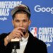 New York Knicks guard Josh Hart drinking from a wine glass at a post-game press conference.