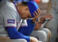 Juan Soto of the New York Mets sitting in the dugout with his head in his hand.
