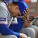 Juan Soto of the New York Mets sitting in the dugout with his head in his hand.