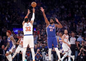 New York Knicks center Karl-Anthony Towns #32 puts up a shot over Philadelphia 76ers center Joel Embiid #21 in the first quarter of an NBA playoff game.