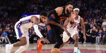 Philadelphia 76ers player Paul George steals the ball from New York Knicks player Karl-Anthony Towns during Game 2 of the Eastern Conference Semifinals.