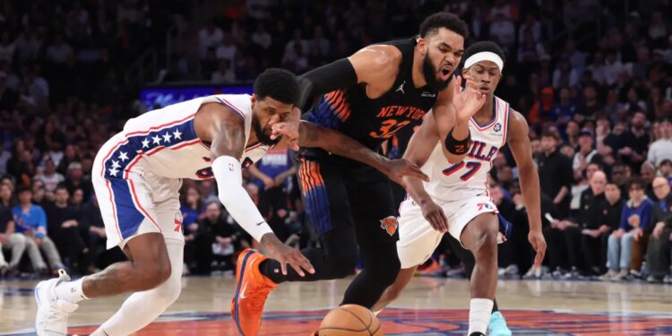 Philadelphia 76ers player Paul George steals the ball from New York Knicks player Karl-Anthony Towns during Game 2 of the Eastern Conference Semifinals.