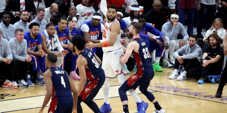 New York Knicks center Karl-Anthony Towns (32) looks for the open man as Cleveland Cavaliers forward Dean Wade (32) defends during the second quarter.