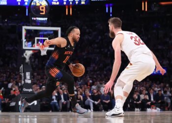 New York Knicks guard Jalen Brunson drives down court against Cleveland Cavaliers forward Dean Wade.