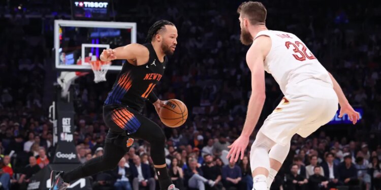 New York Knicks guard Jalen Brunson drives down court against Cleveland Cavaliers forward Dean Wade.