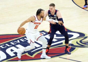 New York Knicks guard Jalen Brunson (11) drives down court as Cleveland Cavaliers guard Sam Merrill (5) gives chase during the second quarter.