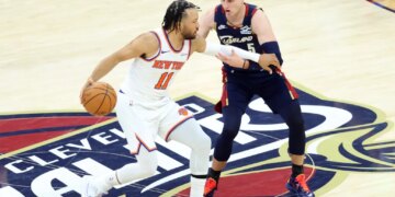 New York Knicks guard Jalen Brunson (11) drives down court as Cleveland Cavaliers guard Sam Merrill (5) gives chase during the second quarter.