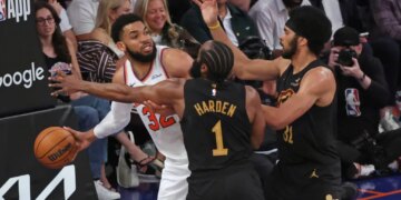 Cleveland Cavaliers guard James Harden #1 and Cleveland Cavaliers center Jarrett Allen #31 double team New York Knicks center Karl-Anthony Towns #32 during the second quarter.