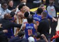 New York Knicks center Mitchell Robinson #23 fighting with Atlanta Hawks guard Dyson Daniels #5.