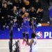 New York Knicks guard Jalen Brunson (11) shoots a three-pointer over Philadelphia 76ers center Joel Embiid (21).