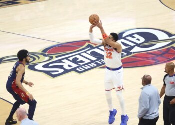 Karl-Anthony Towns (32) shooting a three-point shot over Jarrett Allen (31).