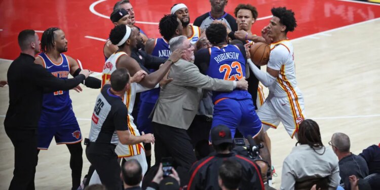 New York Knicks center Mitchell Robinson fighting with Atlanta Hawks guard Dyson Daniels during an NBA playoff game.