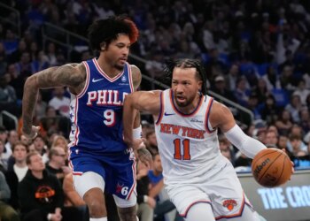 Jalen Brunson of the New York Knicks drives past Kelly Oubre Jr. of the Philadelphia 76ers.