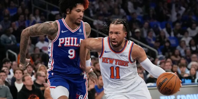 Jalen Brunson of the New York Knicks drives past Kelly Oubre Jr. of the Philadelphia 76ers.