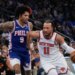 Jalen Brunson of the New York Knicks drives past Kelly Oubre Jr. of the Philadelphia 76ers.