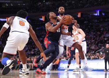 Cleveland Cavaliers guard Donovan Mitchell drives to the basket as New York Knicks guard Mikal Bridges defends.