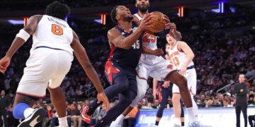 Cleveland Cavaliers guard Donovan Mitchell drives to the basket as New York Knicks guard Mikal Bridges defends.
