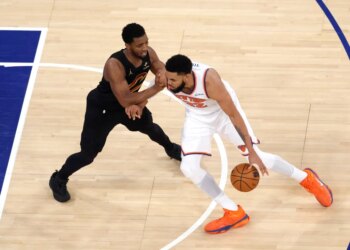 New York Knicks center Karl-Anthony Towns drives to the basket as Cleveland Cavaliers guard Donovan Mitchell defends during Game 1 of the Eastern Conference Finals.