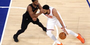 New York Knicks center Karl-Anthony Towns drives to the basket as Cleveland Cavaliers guard Donovan Mitchell defends during Game 1 of the Eastern Conference Finals.