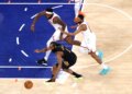 Cleveland Cavaliers guard James Harden (1), New York Knicks center Mitchell Robinson (23), and New York Knicks guard Mikal Bridges (25) chase a loose basketball on the court.