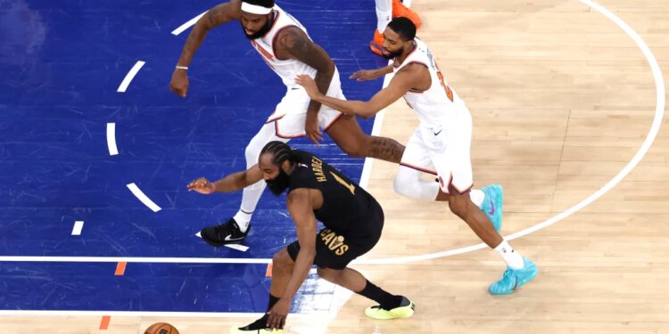 Cleveland Cavaliers guard James Harden (1), New York Knicks center Mitchell Robinson (23), and New York Knicks guard Mikal Bridges (25) chase a loose basketball on the court.
