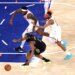 Cleveland Cavaliers guard James Harden (1), New York Knicks center Mitchell Robinson (23), and New York Knicks guard Mikal Bridges (25) chase a loose basketball on the court.